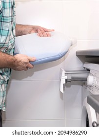 Mudchina, a Caucasian, middle-aged, pours a conditioner for washing clothes into a washing machine. - Shutterstock ID 2094986290