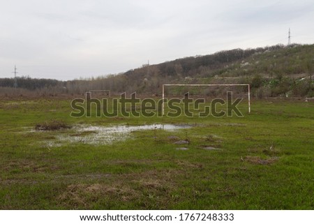 Muddy abandoned football field in rural modern day Romania