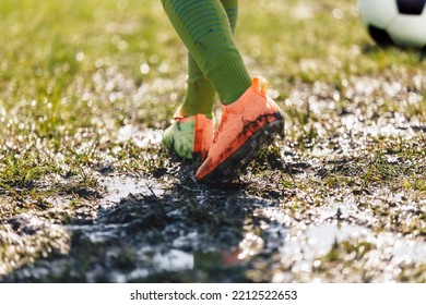 Muddy Football Field. Player Walking On Muddy Soccer Pitch. Soccer Cleats Covered With Mud and Dirt - Powered by Shutterstock