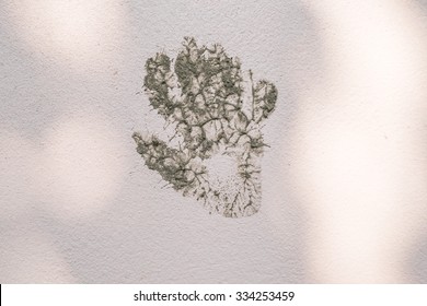 Muddy Hand Print Graffiti On Wall.