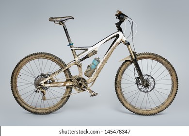 Muddy Mountain Bike Isolated On Grey Background