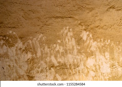 Muddy Old Brown Wall With Hands And Fingers Marks