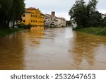 muddy river called FIUME BACCHIGLIONE about to overflow and break protective levees during the flood in VICENZA in italy