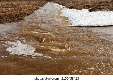 Muddy River Water. Fast Stream With Dirty Water During The Snowmelt In Spring.