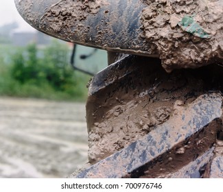 A Muddy Tractor Tire On A Rainy Day. Very Dirty.