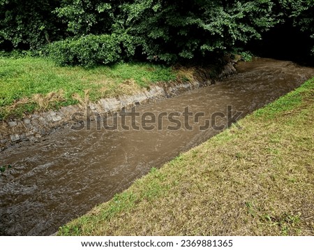 the muddy water moves quickly through the strained riverbed, it is easy to drown, those who fall are swept into the depths under the bridge. the rapid flow of water from field also washes away topsoil