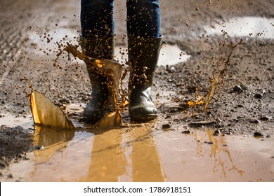 Muddy Water Splashing. Dirt Road Puddle. Water Boots.