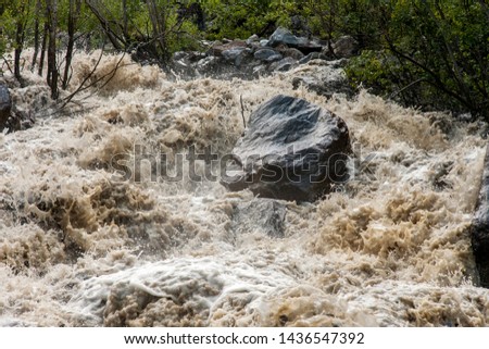 Mudflow, turbulent river in the mountains, flood and stone