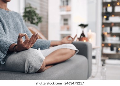 Mudra, hand and meditation on sofa in home for chakra connection, balance and mental health in morning. House, peace and zen person with spiritual healing for holistic, mindfulness and awareness
