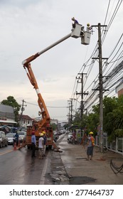 MUENG, MAHA SARAKHAM/THAILAND MAY 2015: Electrical Engineers And Bucket Truck Obstructed On Street For Repairing Power Cable Damage Due To Heavy Rain In Evening Of May 12, 2015 In Maha Sarakham.