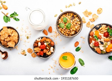 Muesli bowl, organic ingredients for healthy breakfast Granola, nuts, dried fruits, oatmeal, whole grain flakes on white background. Copy space, banner - Powered by Shutterstock