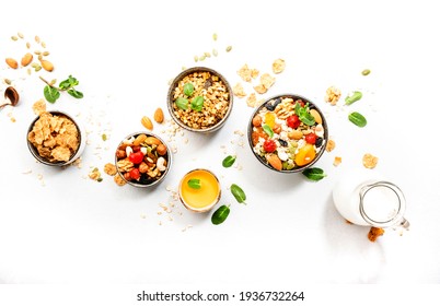 Muesli Bowl, Organic Ingredients For Healthy Breakfast Granola, Nuts, Dried Fruits, Oatmeal, Whole Grain Flakes On White Background. Copy Space, Banner