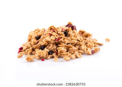 Muesli cereals close up with  raisins, oat and wheat flakes, fruits, strawberry, cranberry, cherry pieces. Isolated on white