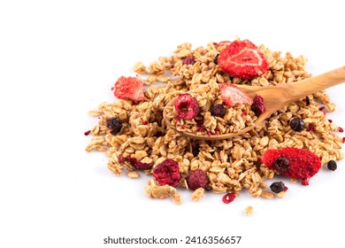 Muesli cereals close up with  raisins, oat and wheat flakes, fruits, strawberry, cranberry, cherry pieces. Isolated on white. In wooden spoon