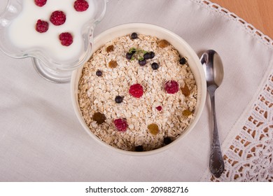 Muesli with raisins and berries and yogurt, delicious healthy breakfast - Shutterstock ID 209882716