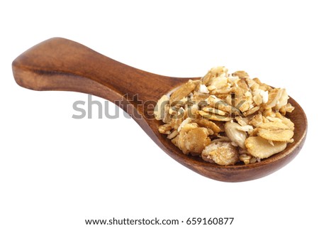 Muesli in spoon over white background.