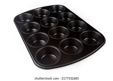 Muffin Cake Pan With Non-stick Coating Isolated On A White Background. 12-cup Muffin Baking Tray. Empty Cupcake Bake Ware For Pie, Tart, Cake And Pastries Concepts. Kitchen Utensils. Top View.