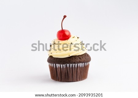 Muffin with topping and a cherry on top, isolated over a white background. With space for text.