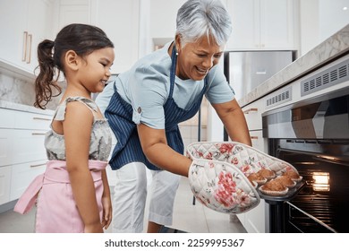 Muffins, learning and grandmother with girl cooking and taking out cupcakes from oven. Education, kitchen and happy grandma teaching child how to bake, bonding and enjoying quality time together. - Powered by Shutterstock