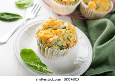 Muffins with spinach, sweet potatoes and cheese on white background. Healthy food concept.