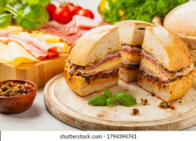 Muffuletta. Sandwich with cheese, ham and olive paste. A traditional recipe in New Orleans. Front view.