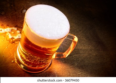 Mug Of Beer Close Up On Wooden Table