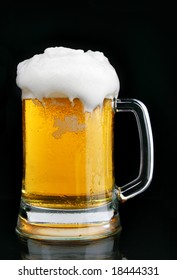 Mug Of Beer With Froth Over Black Background