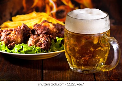 mug of beer and grilled chicken wings