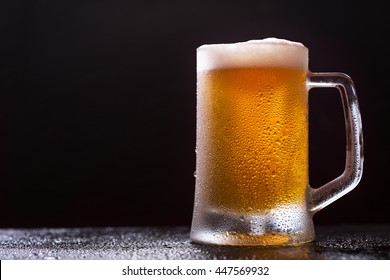 mug of beer on dark background - Shutterstock ID 447569932