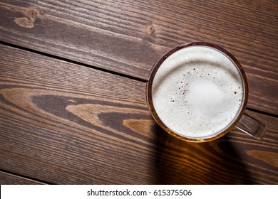 Mug Of Beer On An Old Wooden Table. Top View