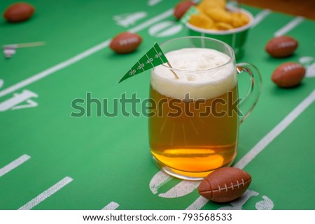mug of beer on snack table decorated for superbowl party
