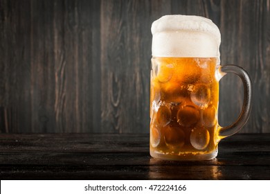 Mug of beer on wooden background - Shutterstock ID 472224166