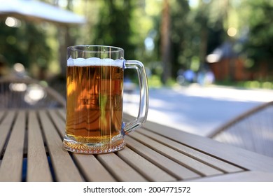 Mug Of Beer On Wooden Table Of Restaurant Veranda