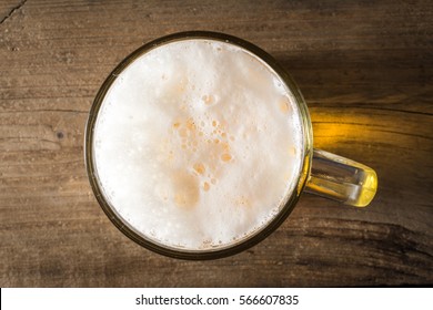 Mug Of Beer On Wooden Table. Top View