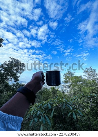 A mug with clouds and trees scenary