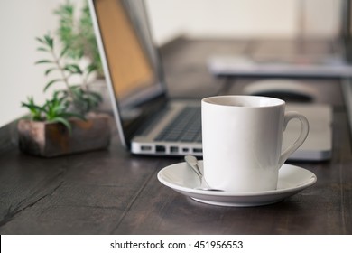 Mug Coffee on wooden work table.