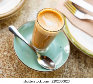 Mug Of Cortado Served On Table In Cafe. Traditional Spanish Coffee.