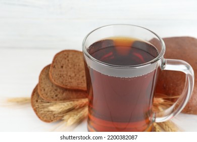 Mug Of Delicious Kvass On White Table, Closeup