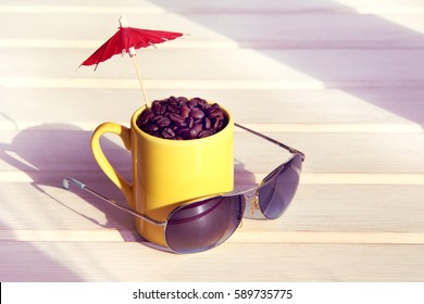 Mug Filled Grains Of Black Coffee, Red Umbrella And Sunglasses / Summer Holiday Concept