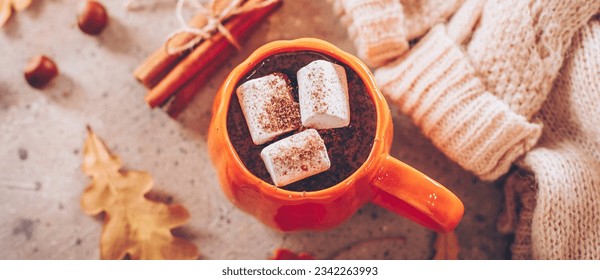 Mug with hot chocolate cacao with marshmallows, cozy warm sweater and cozy decoration. Autumn mood, hygge atmosphere. Flat lay, top view. Banner for web site - Powered by Shutterstock