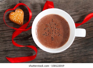 Mug of hot chocolate or cocoa with cookies decorated by red ribbon - Powered by Shutterstock