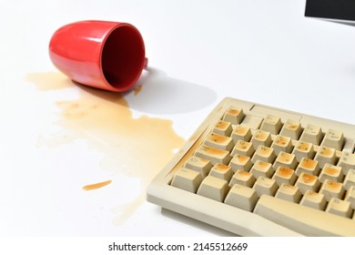 Mug Knocked Over On Computer Keyboard With Spilt Coffee 