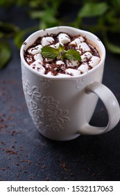 A Mug Of Mint Hot Chocolate With Marshmallows On A Dark Background. White Mug Of Hot Drink Close-up.