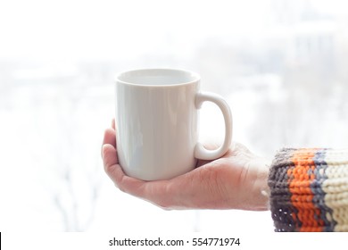 Mug on hand for mockup - Shutterstock ID 554771974