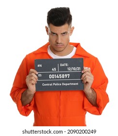 Mug Shot Of Prisoner In Orange Jumpsuit With Board On White Background, Front View