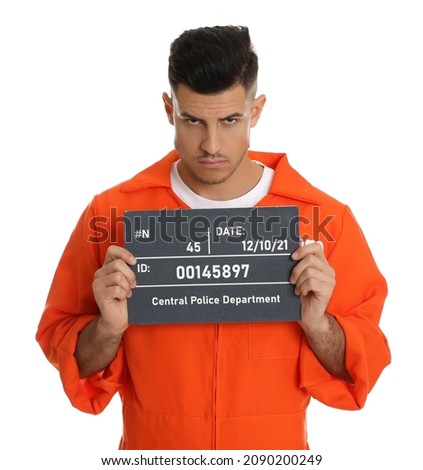 Mug shot of prisoner in orange jumpsuit with board on white background, front view