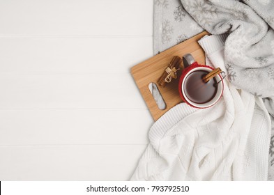 Mug With Tea And Home Decor On White, Cosy Wooden Table Background. Winter Morning Relax Concept, Top View. Frame With Cup And Copy Space Around Objects.