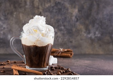 Mug of Viennese coffee with whipped cream and cinnamon on the table - Powered by Shutterstock