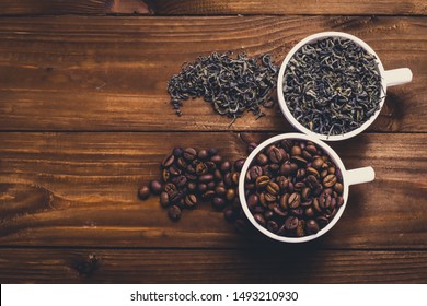 Mugs With Coffee And Dried Tea On Wooden Table