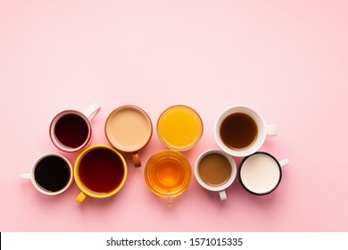 Mugs Glasses With Various Traditional Drinks Coffee Tea Juice On Pink Background. Flat Layout Top View. Drinks Concept.